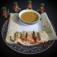 A picture of Jini dosa with sambhar.