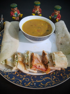 A picture of Jini dosa with sambhar.