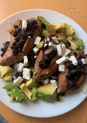 A picture of Black bean, avocado and feta stuffed sweet potatoes (vegetarian).