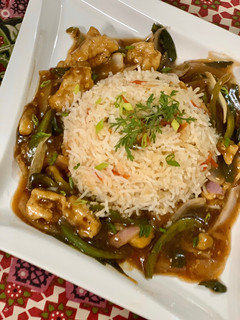A picture of Mongolian Chicken with vegetable rice.