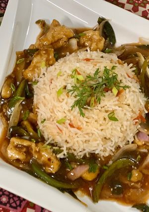 A picture of Mongolian Chicken with vegetable rice.