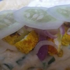 A picture of Tortilla wrap filled grilled cheesy white sauce.