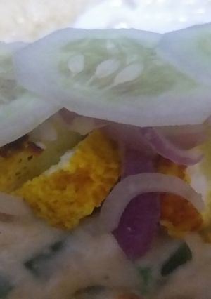 A picture of Tortilla wrap filled grilled cheesy white sauce.