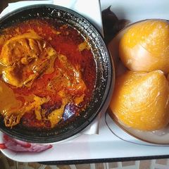 A picture of Banga soup with fresh fish,and starch.