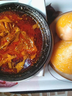 A picture of Banga soup with fresh fish,and starch.