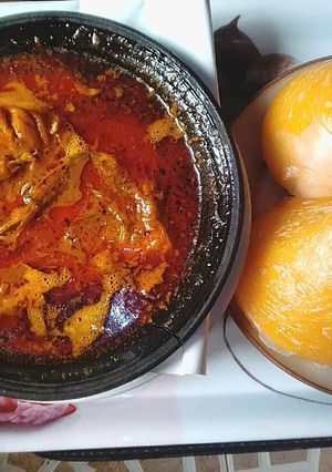 A picture of Banga soup with fresh fish,and starch.