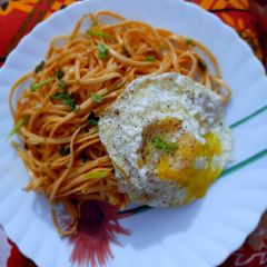 A picture of Udon Noodles with poached egg.