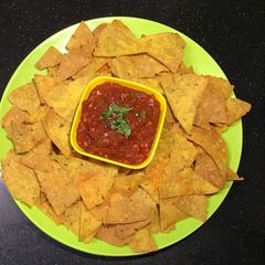A picture of Nachos with Tomato Salsa.
