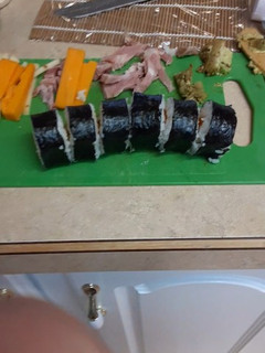 A picture of Ham, Cheese and avocado sushi.