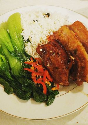 A picture of Braised Chinese Pork Belly w Pak choi served with boiled rice.