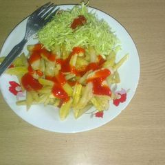 A picture of Fried potatoes with avocado cabbage salad.