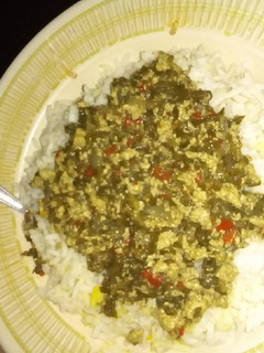 A picture of White rice and tofu and spinach sauce.