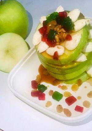 A picture of Green apples loaded with nuts salad.