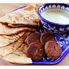 A picture of Allo ka Paratha - Potato stuffed buttered flat bread.