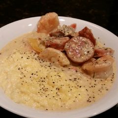 A picture of Brads Cajun prawns with sausage and grits.
