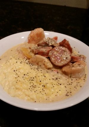 A picture of Brads Cajun prawns with sausage and grits.