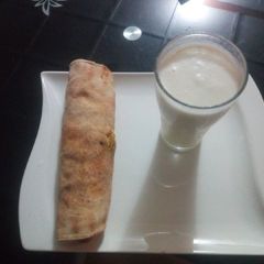 A picture of Tortilla wrap with banana and coconut smoothie.