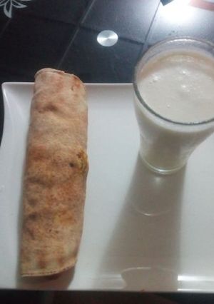 A picture of Tortilla wrap with banana and coconut smoothie.