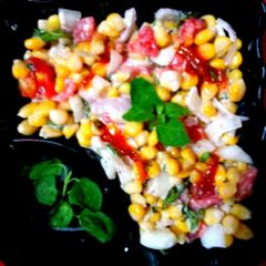 A picture of Sweet corn kernels Tomato onion salad.