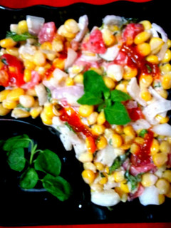 A picture of Sweet corn kernels Tomato onion salad.