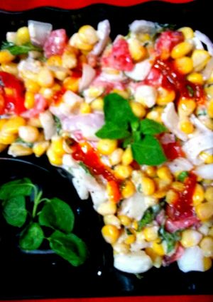 A picture of Sweet corn kernels Tomato onion salad.