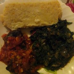 A picture of Butternut ugali with fish and kienyeji greens.