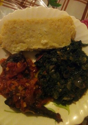 A picture of Butternut ugali with fish and kienyeji greens.