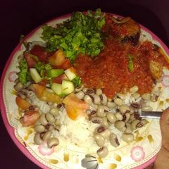 A picture of Shinkafa da wake with salad and stew.