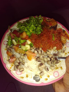 A picture of Shinkafa da wake with salad and stew.