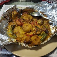 A picture of Baked Capsicum,tomato,paneer,mushroom,soya champ and onion.