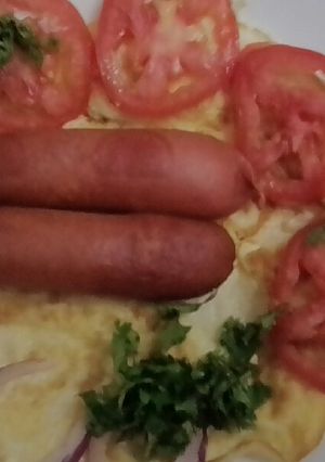 A picture of Fried eggs and smokies.