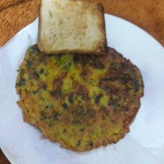 A picture of Besan methi cheela with toasted brown bread.