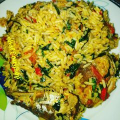 A picture of My emergency jollof rice with pumpkin/ugu leaf.