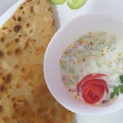 A picture of Aloo ke parathy with cucumber raita.
