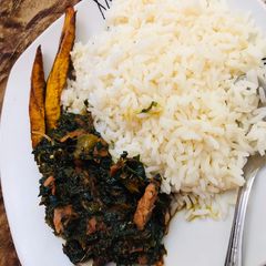 White rice,vegetable source and smoked fish A picture of White rice,vegetable source and smoked fish.