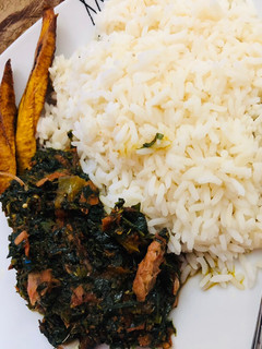 A picture of White rice,vegetable source and smoked fish.