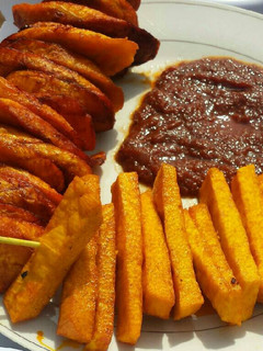 A picture of Palm oil fried yam,plantain with tomatoes sauce.