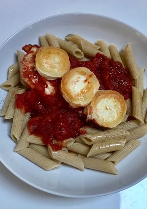 A picture of Baked Chicken and Goats Cheese served with whole grain pasta.