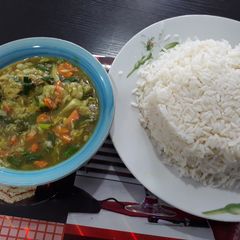 A picture of White rice with chicken sauce.