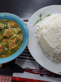 A picture of White rice with chicken sauce.