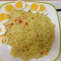 A picture of Noodles with cooked eggs.