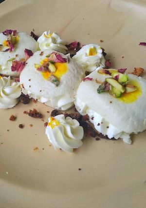 A picture of Malai sandwich with kesar mousse and pistachio crunches.