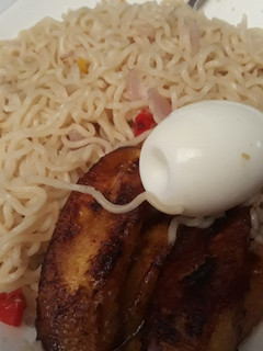 A picture of Indomine with fried plantain and egg.
