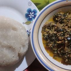 A picture of Egusi soup with scent leaf and uzuza seed.