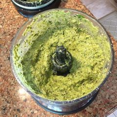 A picture of Besil pesto sauce with parmesan cheese.