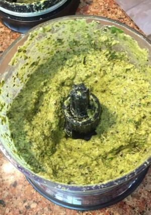 A picture of Besil pesto sauce with parmesan cheese.