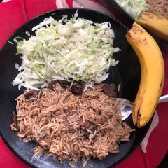 A picture of Beef pilau and steamed cabbages.