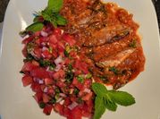 Una foto de sardinas con tomate con cilantro