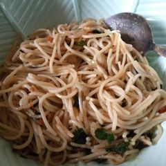 A picture of Jollof spaghetti with moringa.