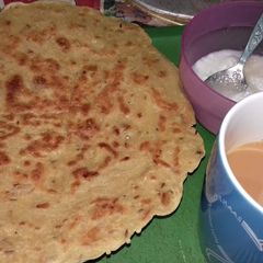 A picture of Baisan ka paratha with chai.